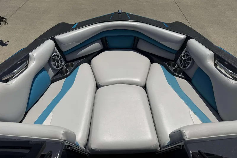 Slide: The Image of 2016 Axis A22 boat interior with gray and blue cushioned seating. - 8