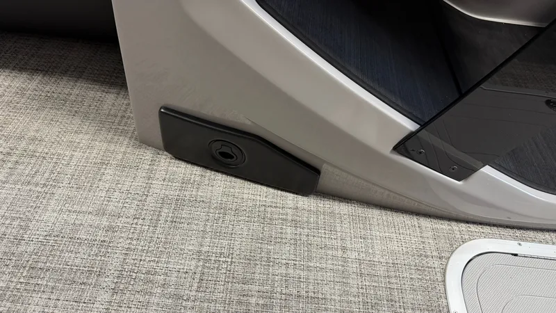 Slide: The Image of Close-up of a part of the 2027 Barletta CABRIO24QC with gray carpet flooring. - 42