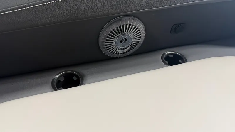 Slide: The Image of Close-up of a boat seat with a vent and cup holders. - 16
