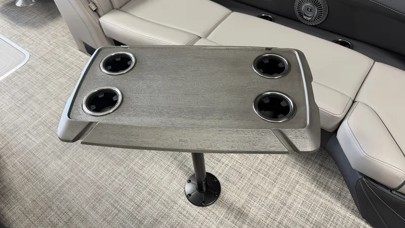 Slide: The Image of A sleek table with four cup holders on a Barletta CABRIO24QC boat. - 29