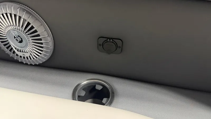 Slide: The Image of Close-up of a boat interior featuring a fan and a cup holder. - 17