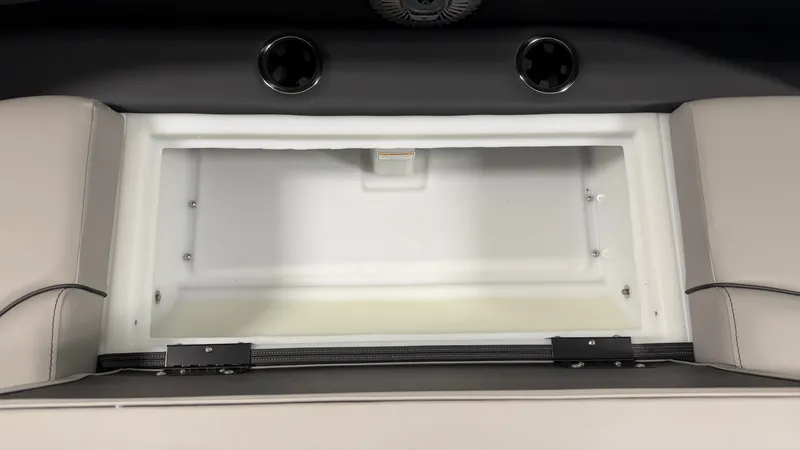 Slide: The Image of An open storage compartment with padded sides and two cup holders above. - 18