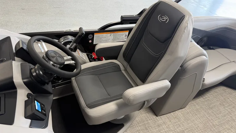 Slide: The Image of The interior of a 2027 Barletta CABRIO24QC features a sleek captain's chair and modern dashboard. - 46