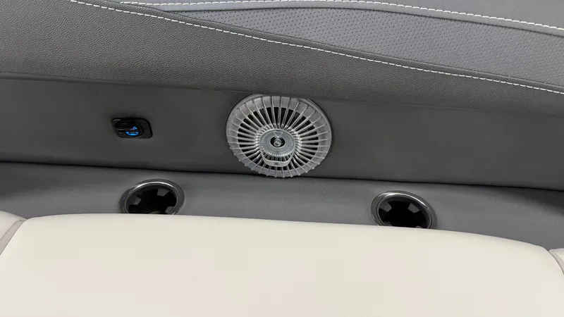 Slide: The Image of Close-up of a boat seat with a vent and cup holders. - 27
