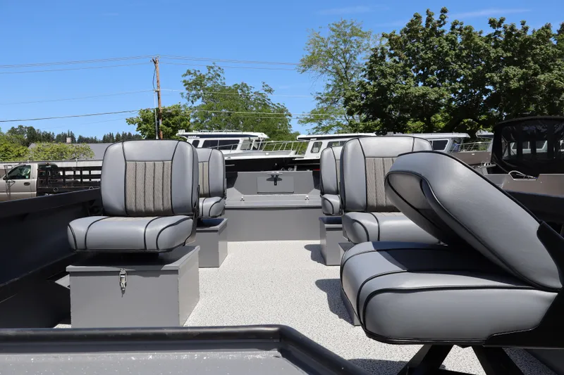Slide: The Image of 2026 Alumaweld Super Vee Pro 21 boat interior with gray seating under clear blue sky. - 6