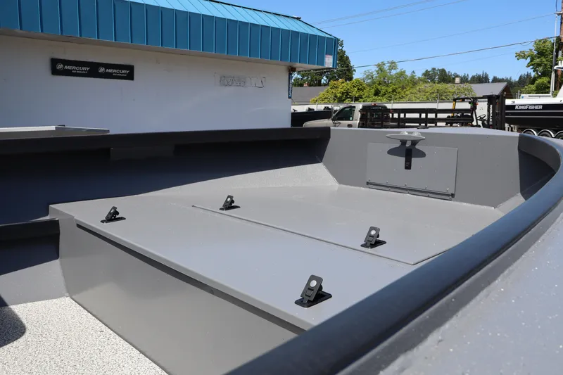 Slide: The Image of 2026 Alumaweld Super Vee Pro 21 boat interior with gray finish, docked outdoors. - 7