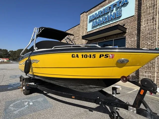 Slide: The Image of Yellow Monterey 224 FS boat in front of Marietta Marine building. - 2