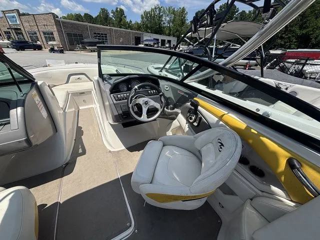 Slide: The Image of Interior of a 2012 Monterey 224 FS boat with steering wheel and seats. - 21