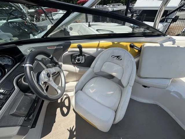 Slide: The Image of Interior of a 2012 Monterey 224 FS BR boat with steering wheel and seat. - 25