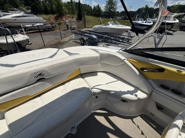 Slide: The Image of Interior of a 2012 Monterey 224 FS BR boat with yellow accents. - 27