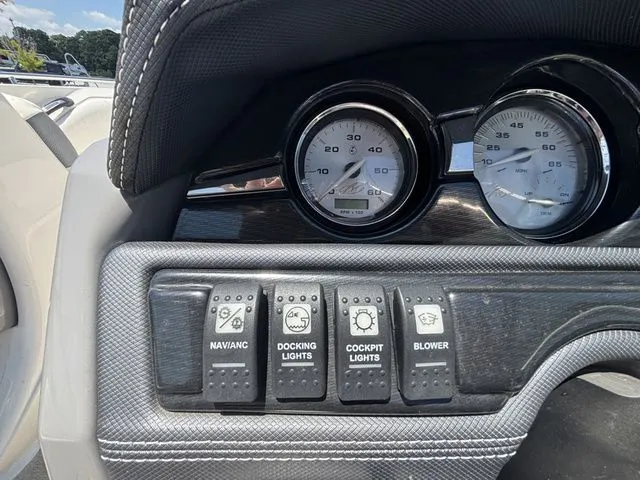 Slide: The Image of Dashboard of a 2012 Monterey 224 FS BR boat with switches and gauges. - 32