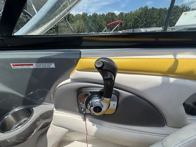 Slide: The Image of Interior view of a 2012 Monterey 224 FS BR boat with throttle lever. - 35