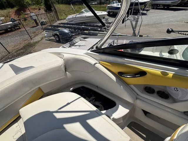 Slide: The Image of Interior of a 2012 Monterey 224 FS BR boat with yellow accents. - 49
