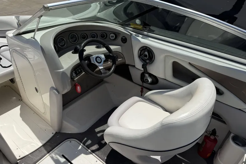 Slide: The Image of Interior of a 2010 Bryant 233 boat featuring steering wheel and dashboard controls. - 11