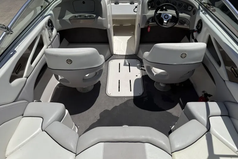 Slide: The Image of Interior of a 2010 Bryant 233 boat with gray seating and steering console. - 20