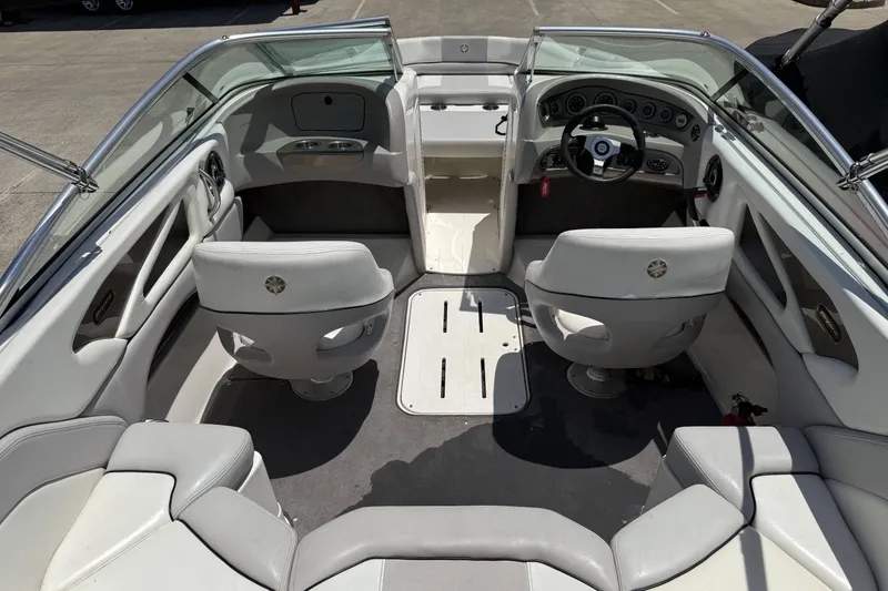 Slide: The Image of Interior of a 2010 Bryant 233 boat with seating and steering wheel. - 21