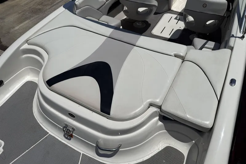 Slide: The Image of 2010 Bryant 233 boat interior with white and gray seating. - 22
