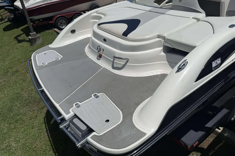 Slide: The Image of Rear view of a 2010 Bryant 233 boat with swim platform and seating area. - 24