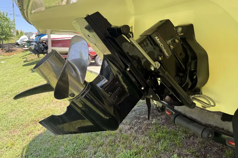 Slide: The Image of Close-up of a 2010 Bryant 233 boat's MerCruiser outdrive on grass. - 25