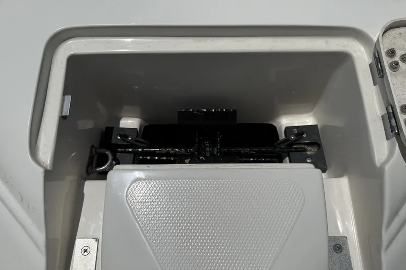 Slide: The Image of Storage compartment of a 2010 Bryant 233 boat, featuring a secured anchor system. - 5