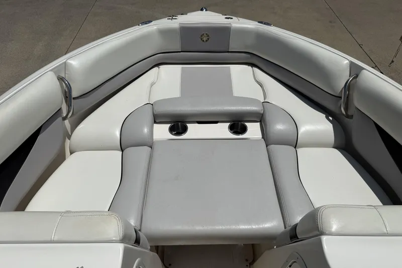 Slide: The Image of 2010 Bryant 233 boat interior with white and gray cushioned seating. - 7