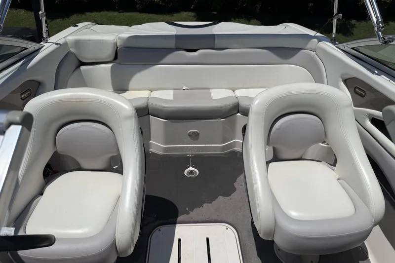 Slide: The Image of Interior of a 2010 Bryant 233 boat with white seating and sleek design. - 8