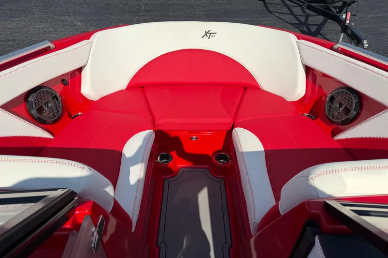 Slide: The Image of Red and white interior of 2021 Masercraft XT22 boat with speakers and seating. - 10