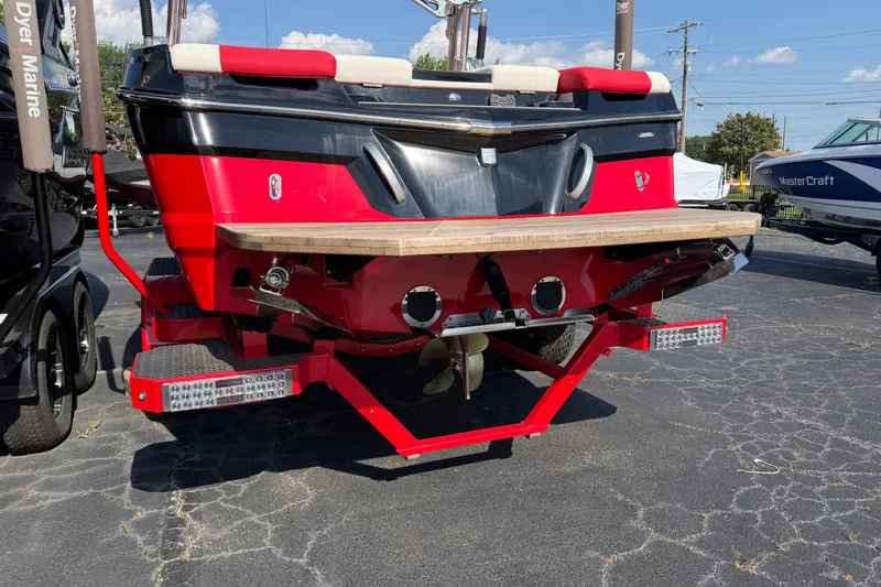 Slide: The Image of Red 2021 Masercraft XT22 boat rear view with swim platform and propeller. - 4
