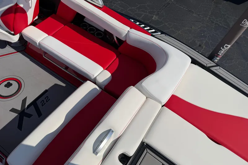 Slide: The Image of Red and white interior of 2021 Masercraft XT22 boat, showcasing seating and flooring design. - 6