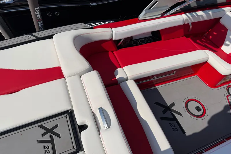 Slide: The Image of Red and white interior of 2021 Masercraft XT22 boat, featuring stylish seating and flooring. - 7