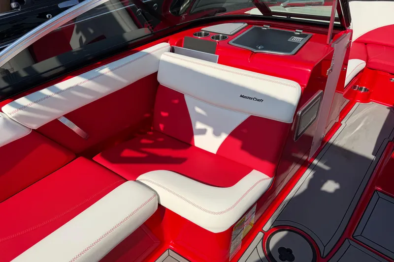 Slide: The Image of Red and white interior of a 2021 Masercraft XT22 boat, featuring comfortable seating. - 8