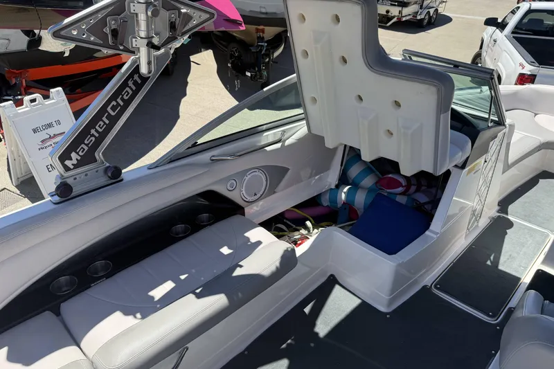 Slide: The Image of 2008 MasterCraft X-45 boat interior with storage compartment open, showcasing seating and accessories. - 11