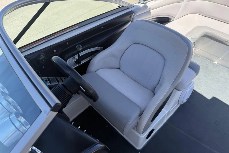 Slide: The Image of 2008 MasterCraft X-45 boat interior with steering wheel and gray captain's seat. - 12
