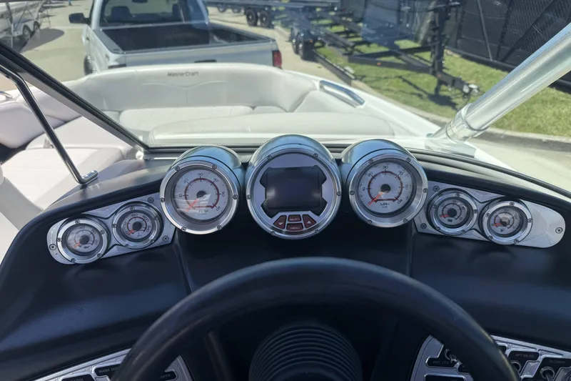 Slide: The Image of Dashboard of a 2008 MasterCraft X-45 boat with gauges and steering wheel. - 15