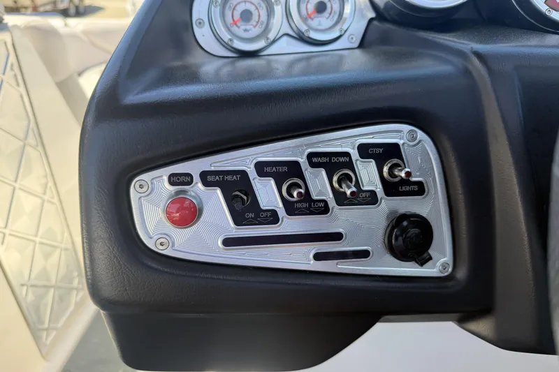 Slide: The Image of Control panel of a 2008 MasterCraft X-45 boat with switches and gauges. - 17