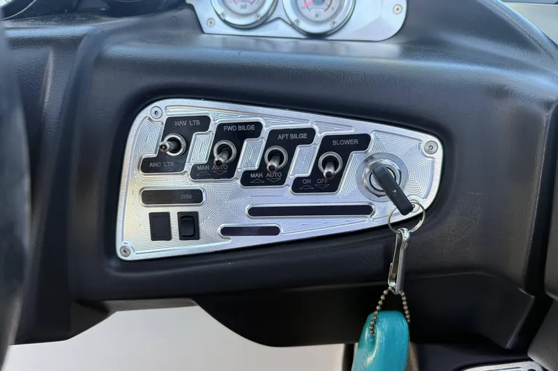 Slide: The Image of Control panel of a 2008 MasterCraft X-45 boat with key ignition and switches. - 18