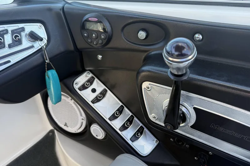 Slide: The Image of 2008 MasterCraft X-45 boat dashboard with controls and steering lever. - 19