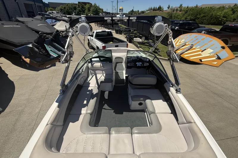 Slide: The Image of 2008 MasterCraft X-45 boat interior with seating and wakeboard tower in a parking lot. - 24