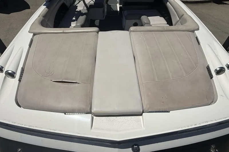 Slide: The Image of 2008 MasterCraft X-45 boat interior with beige upholstery and visible wear. - 28