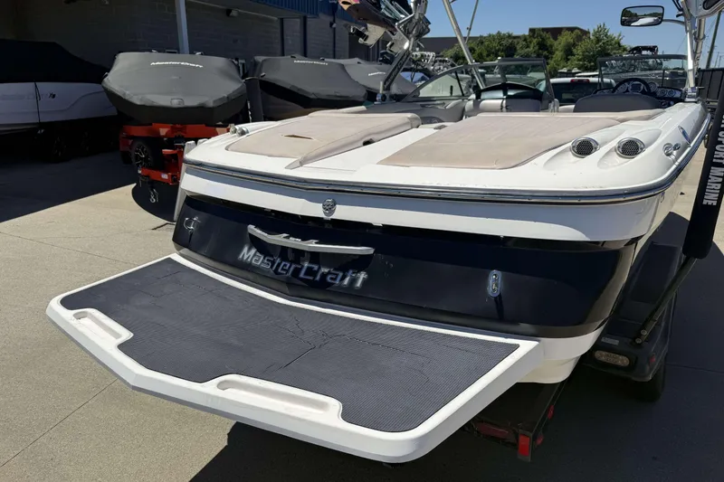 Slide: The Image of 2008 MasterCraft X-45 boat with swim platform, parked outdoors. - 29