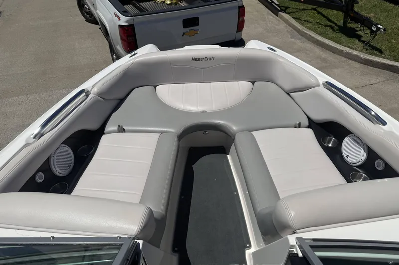 Slide: The Image of 2008 MasterCraft X-45 boat interior with gray seating and cup holders, parked near a Chevrolet truck. - 8