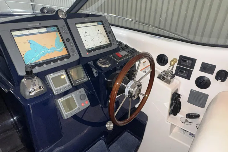 Slide: The Image of Helm of 2007 Tiara Yachts 4300 Sovran with navigation displays and controls. - 16