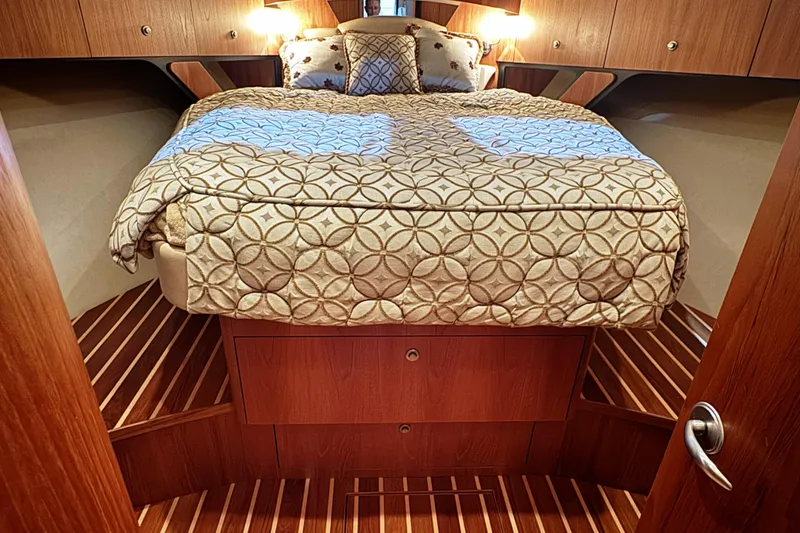 Slide: The Image of Luxurious cabin interior of 2007 Tiara Yachts 4300 Sovran with elegant bedding. - 24
