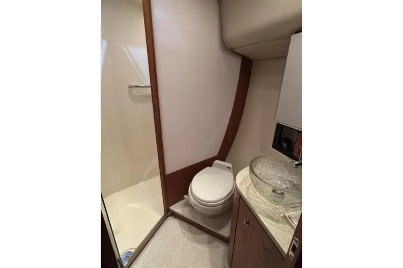 Slide: The Image of Bathroom interior of 2007 Tiara Yachts 4300 Sovran with shower and glass sink. - 27