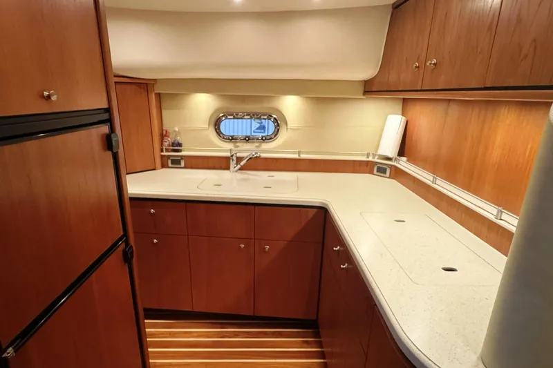 Slide: The Image of Luxurious 2007 Tiara Yachts 4300 Sovran galley with wood cabinetry and modern amenities. - 28