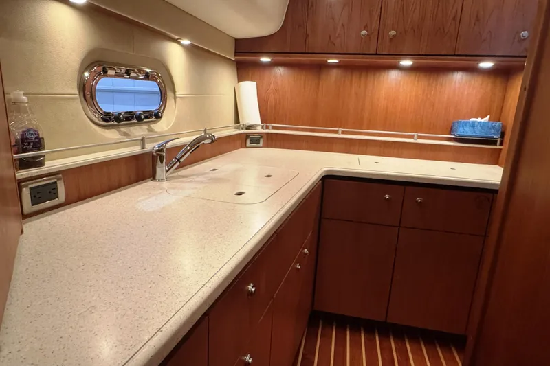 Slide: The Image of Luxurious 2007 Tiara Yachts 4300 Sovran kitchen with wood cabinetry and modern fixtures. - 29
