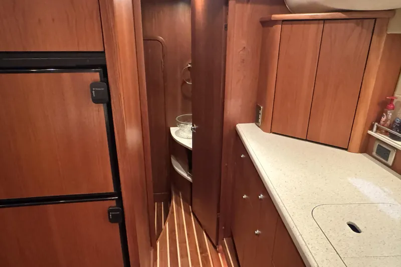 Slide: The Image of 2007 Tiara Yachts 4300 Sovran interior with wood cabinetry and modern kitchen amenities. - 30