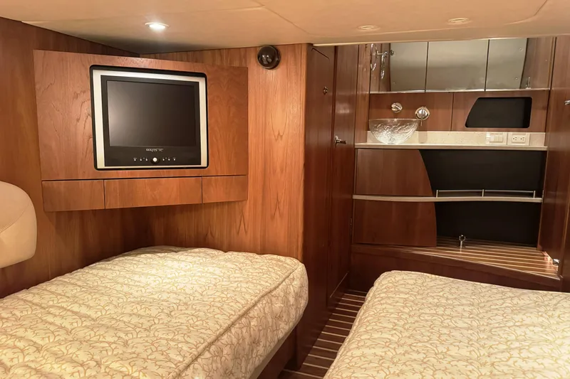 Slide: The Image of Luxurious 2007 Tiara Yachts 4300 Sovran cabin with twin beds and elegant wood finish. - 32