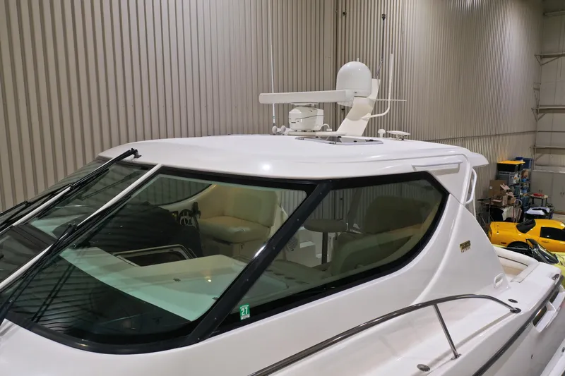 Slide: The Image of 2007 Tiara Yachts 4300 Sovran in indoor storage, showcasing sleek design and radar equipment. - 5