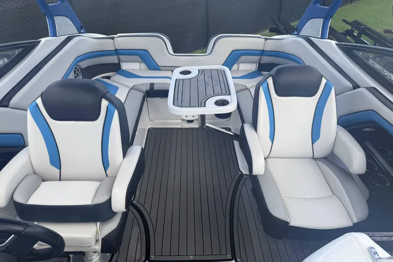 Slide: The Image of 2018 Yamaha Boats 242X E-Series interior with sleek dashboard and seating. - 11